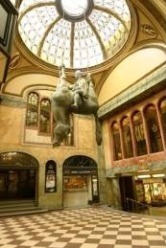Obr.&nbsp;2 Prosklené střechy Paláce Lucerna a)&nbsp;prosklená kopule – interiér